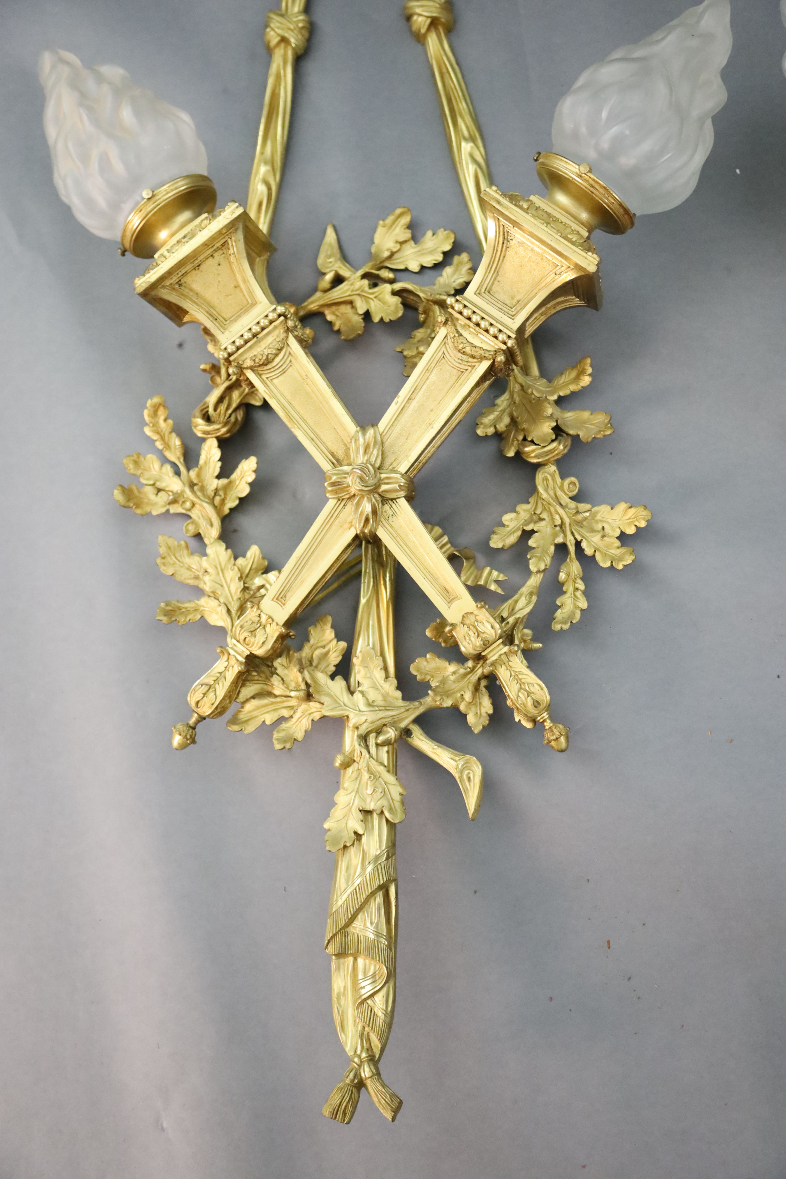 A pair of early 20th century Louis XVI style ormolu wall lights, width 1ft 10in. height 4ft 2in.